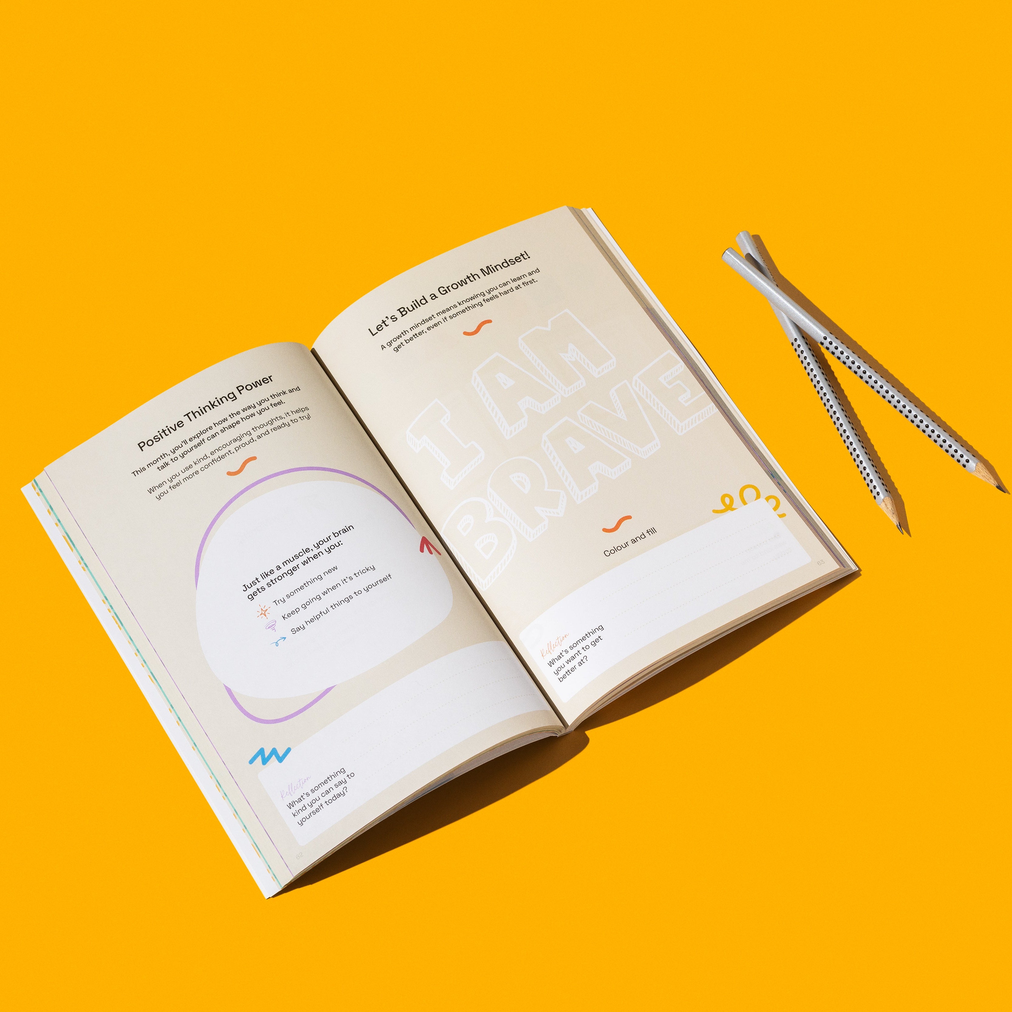 Open book with a pen on an orange background